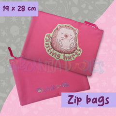 Pink zip pouch with cartoon hedgehog face graphic and zipper pull