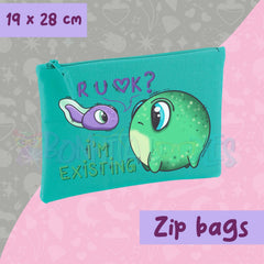 Teal zip pouch with cartoon dinosaur face and long zipper pull
