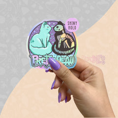 Large holographic vinyl sticker with cartoon cat and skeleton hugging, shiny purple finish